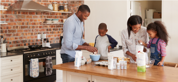 An African American family in the kitchen making a meal